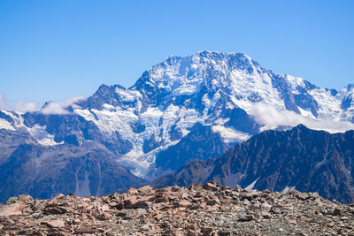 Scenic view of snowcapped mountains against clear blue sky