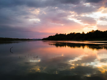 Scenic view of lake against orange sky