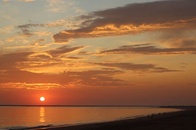 Scenic view of sea against romantic sky at sunset