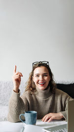 Eureka excited female entrepreneur with successful business idea, sitting at kitchen table with