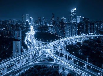 High angle view of illuminated city buildings at night