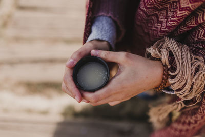 Midsection of woman holding drink