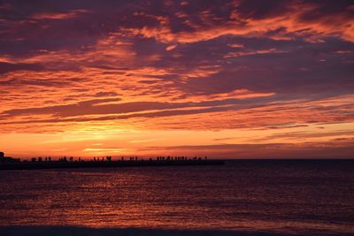 Scenic view of sea against romantic sky at sunset