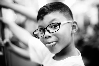 Close-up portrait of smiling boy with glasses