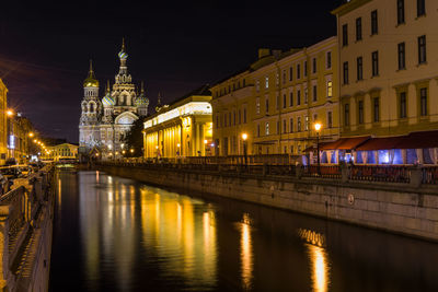 Reflection of illuminated buildings in city at night