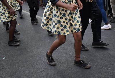 Low section of people dancing on road