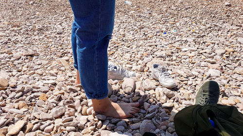 Low section of man standing on rock