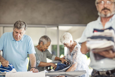 Seniors ironing clothes together