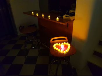 Illuminated light bulbs on table at night