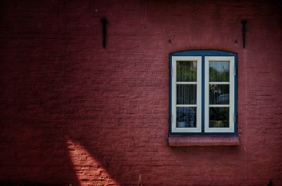 Full frame shot of window on brick wall of building