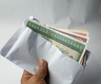 High angle view of hand holding book