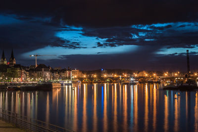 Illuminated buildings in city at waterfront