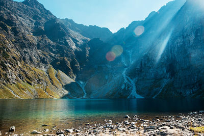 Scenic view of lake and mountains against sky