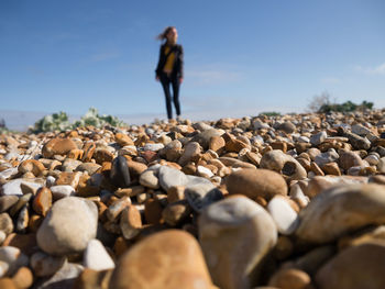 Woman standing on pebbles