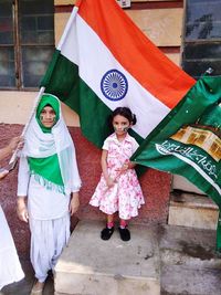Portrait of girls standing with flags