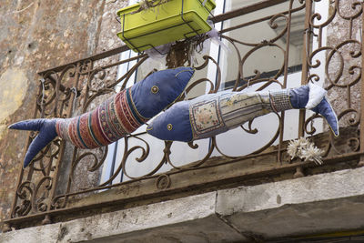 Close-up of hand against built structure