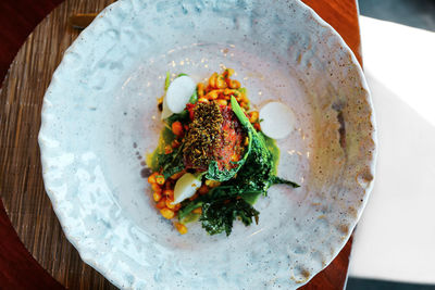 High angle view of meal served in white antique textured plate. 