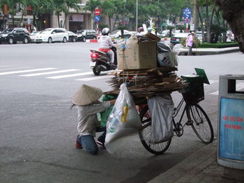 Rear view of woman cycling on street