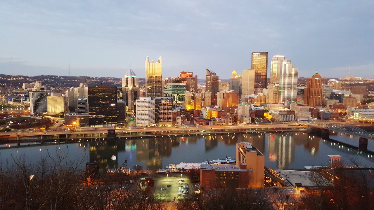 architecture, city, cityscape, skyscraper, building exterior, modern, built structure, reflection, no people, sky, urban skyline, illuminated, travel destinations, outdoors, water, day