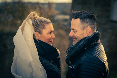 Rear view of couple kissing outdoors