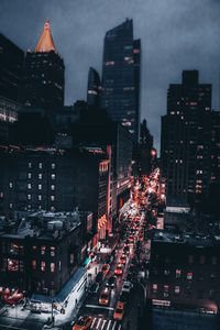 High angle view of illuminated city buildings at night