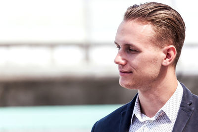 Smiling businessman looking away outdoors