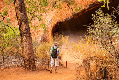 Full length of man hiking in forest