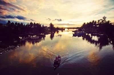 Scenic view of sea against cloudy sky at sunset