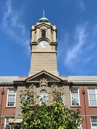 Low angle view of clock tower against sky