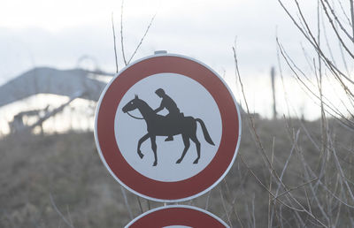 Horse riding ban road sign, red circle with pictogram of horse and rider