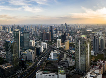 High angle view of modern buildings in city against sky