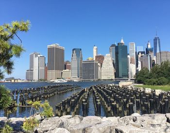 Skyscrapers in city against clear blue sky