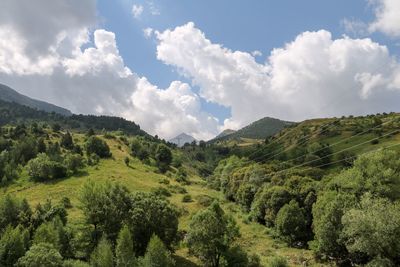 Panoramic shot of countryside landscape against clouds