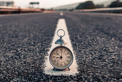 Close-up of clock on road