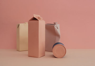 Close-up of containers on table against wall