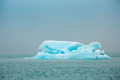 Scenic view of sea against clear sky during winter