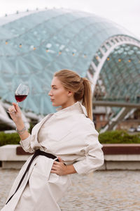 Young woman drinking wine in the park