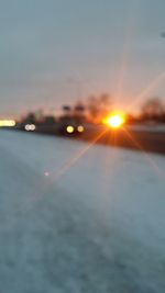 Close-up of illuminated road against sky during sunset