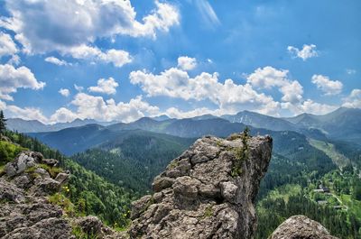 Scenic view of mountains against cloudy sky