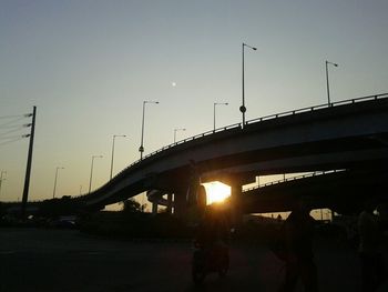 Cars on road at sunset