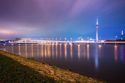 Illuminated macau tower and sai van bridge over praia grande bay against sky