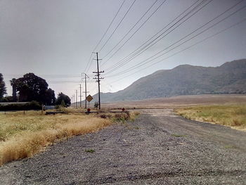 Road leading towards mountains against sky