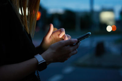 Midsection of woman using mobile phone