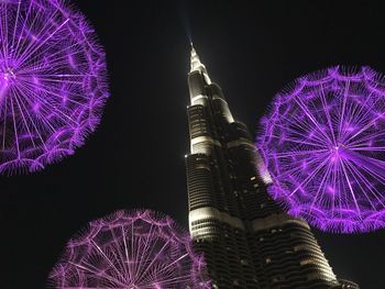 Low angle view of firework display at night