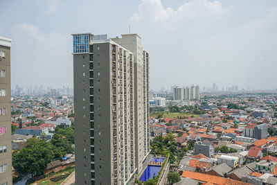 Buildings in city against sky