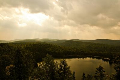 Scenic view of lake against cloudy sky