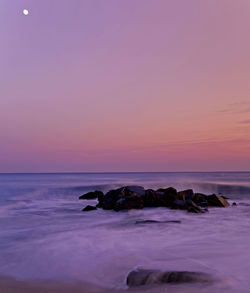 Scenic view of sea against sky at sunset