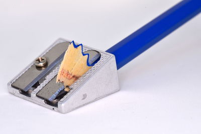 High angle view of pencils on table against white background