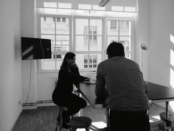 Colleagues discussing at table in office