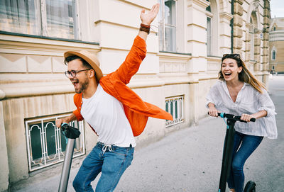 Happy young woman with arms raised